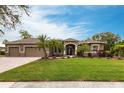 Landscaped yard with a two-story house and a two-car garage at 3826 E 155Th E Ave, Parrish, FL 34219