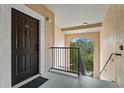 Condo entryway with dark brown door and stairs at 4110 Central Sarasota Pkwy # 136, Sarasota, FL 34238