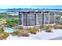 Luxury beachfront condo building with pool and lush landscaping at 415 L Ambiance Dr # A701, Longboat Key, FL 34228