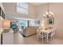 Bright dining area with chandelier and view into living room at 4230 Castlebridge Ln # 1821, Sarasota, FL 34238