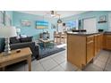 Living room with a light blue wall, gray couch, and dining area with a view at 475 Benjamin Franklin Dr # 215, Sarasota, FL 34236