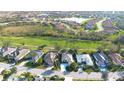 An aerial view highlights the property's desirable location within a community close to a lake, golf course, and green space at 4837 88Th E St, Bradenton, FL 34211