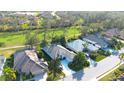 Aerial view of the home showcasing its location within a well-kept community near a golf course and pond at 4837 88Th E St, Bradenton, FL 34211