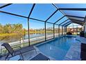 Screened pool and patio area with lake view at 5522 69Th E Pl, Ellenton, FL 34222