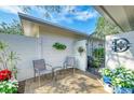 Inviting front patio with seating area and decorative gate at 6005 Midnight Pass Rd # N8, Sarasota, FL 34242