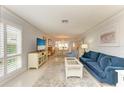 Bright and airy living room with ample seating and large windows at 6005 Midnight Pass Rd # N8, Sarasota, FL 34242
