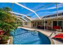 Inviting kidney-shaped pool with a screened enclosure and patio furniture at 6607 39Th Avenue W Cir, Bradenton, FL 34209