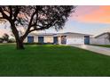 Beautiful blue house with a lush green lawn at 6902 22Nd W Ave, Bradenton, FL 34209