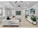 Spacious living room with light colored sectional sofa, large TV, and plenty of natural light at 7946 Tybee Ct, University Park, FL 34201