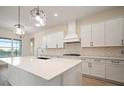 Modern kitchen with white cabinets, quartz countertops, and island at 8528 Beechlake Ct, Sarasota, FL 34240