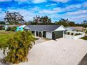 Single story home with gray siding and white shell driveway at 905 69Th Nw St, Bradenton, FL 34209