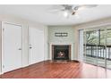 Living room with fireplace and sliding glass doors to balcony at 9100 Dr Martin Luther King Jr N St # 1302, St Petersburg, FL 33702