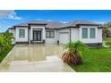 Modern single-story home with gray roof and white walls at 10155 Hallendale Dr, Port Charlotte, FL 33981