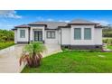 Modern single-story home with gray roof and white walls at 10155 Hallendale Dr, Port Charlotte, FL 33981