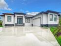Modern single-story home with gray roof and white walls at 10155 Hallendale Dr, Port Charlotte, FL 33981