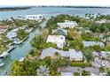 Aerial view of waterfront home with lush landscaping and private dock at 115 Edmondson Ave, Sarasota, FL 34242