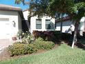 Landscaped front yard with lush greenery and manicured bushes at 11992 Blazing Star Dr, Venice, FL 34293