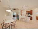 Open kitchen with white island, breakfast bar, and dining area at 12338 Lavender Loop, Bradenton, FL 34212
