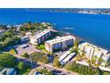 A stunning bird's eye view of a waterfront condominium complex with lush landscaping and a glimpse of the marina at 1600 1St W Ave # 304A, Bradenton, FL 34205