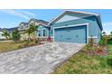 Gray paved driveway leading to a light blue house at 16257 S Port Harbor Blvd, Port Charlotte, FL 33953