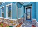 Front door entrance with stone detailing and a welcome sign at 16257 S Port Harbor Blvd, Port Charlotte, FL 33953