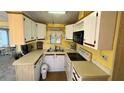 Functional kitchen featuring white cabinets and modern appliances at 289 Bainbridge Dr, Nokomis, FL 34275