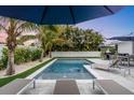 Refreshing pool with lounge chairs and a patio area at 306 66Th St, Holmes Beach, FL 34217