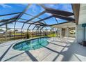 Inviting kidney-shaped pool with screened enclosure at 4430 Wynkoop Cir, Port Charlotte, FL 33948