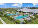 Aerial view of resort-style pool with expansive deck and clubhouse at 4886 Seafoam Trl, Bradenton, FL 34211