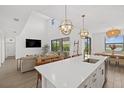 Modern kitchen island with white quartz countertops and gold accents at 4886 Seafoam Trl, Bradenton, FL 34211