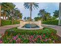 Gated community entrance with a fountain and landscaping at 523 N Spoonbill Dr, Sarasota, FL 34236