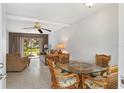 Bright dining area with table and chairs, open to living room at 5889 Canal Dr # I4, Bradenton, FL 34207