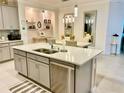 Modern kitchen with island, stainless steel appliances, and an eat-in area at 6014 Fiore Dr, Bradenton, FL 34208