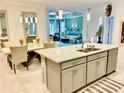 Spacious kitchen features an island with seating and opens to dining area at 6014 Fiore Dr, Bradenton, FL 34208