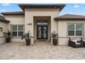 Elegant entryway with double doors and a paver driveway at 7139 Tamworth Pkwy, Sarasota, FL 34241