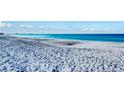 Expansive sandy beach with ocean waves and clear blue water at 800 Benjamin Franklin Dr # 202, Sarasota, FL 34236