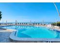 Relaxing beachfront pool with ocean view and lounge chairs at 800 Benjamin Franklin Dr # 202, Sarasota, FL 34236