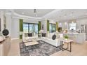 Spacious living room with two sofas, coffee tables and access to a patio at 8024 Moonbeam Ave, Sarasota, FL 34241