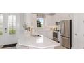 Modern kitchen with stainless steel appliances and white cabinets at 8053 Moonbeam Ave, Sarasota, FL 34241
