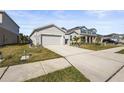 Two-car garage, driveway, and street view of the house at 9810 Eventide Trl, Parrish, FL 34219