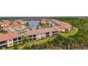 Wide angle aerial view of townhomes and lush green landscape at 10031 Crooked Creek Dr # 201, Venice, FL 34293