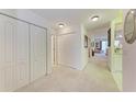 Bright hallway with white doors and carpet flooring at 1105 Gondola Park Dr # 1105, Venice, FL 34292