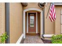 Front entry with arched doorway and brick walkway at 12785 Fontana Loop, Bradenton, FL 34211