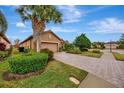 Home exterior showcasing a paver driveway and lush landscaping at 12785 Fontana Loop, Bradenton, FL 34211