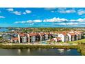 Aerial view of waterfront condo community with pool and lush landscaping at 1608 Stickney Point Rd # 1608-102, Sarasota, FL 34231