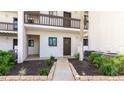 Condo building exterior featuring walkway and landscaping at 1608 Stickney Point Rd # 1608-102, Sarasota, FL 34231