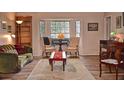 Spacious living room with hardwood floors, bay window, and comfortable seating at 1864 Mid Ocean Cir, Sarasota, FL 34239