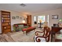 Living room features hardwood floors, bay window and built-in shelving at 1864 Mid Ocean Cir, Sarasota, FL 34239