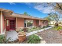 Well-maintained home with a welcoming front entrance, beautiful stone accents, and lush, manicured landscaping at 2218 Shadow Oaks Rd, Sarasota, FL 34240