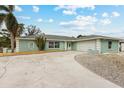 Ranch style home with a two car garage and palm trees at 2808 68Th Street W Cir, Bradenton, FL 34209